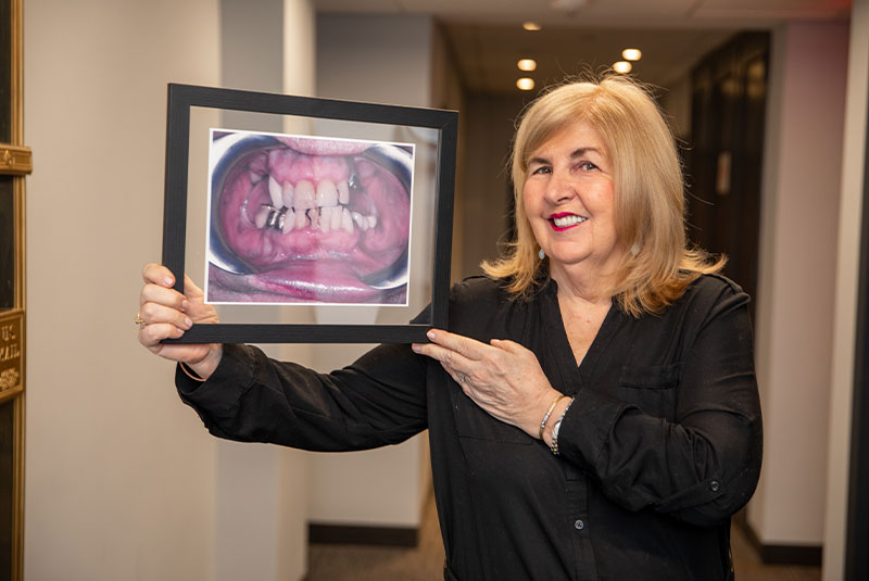 a female patient showing an image of her teeth